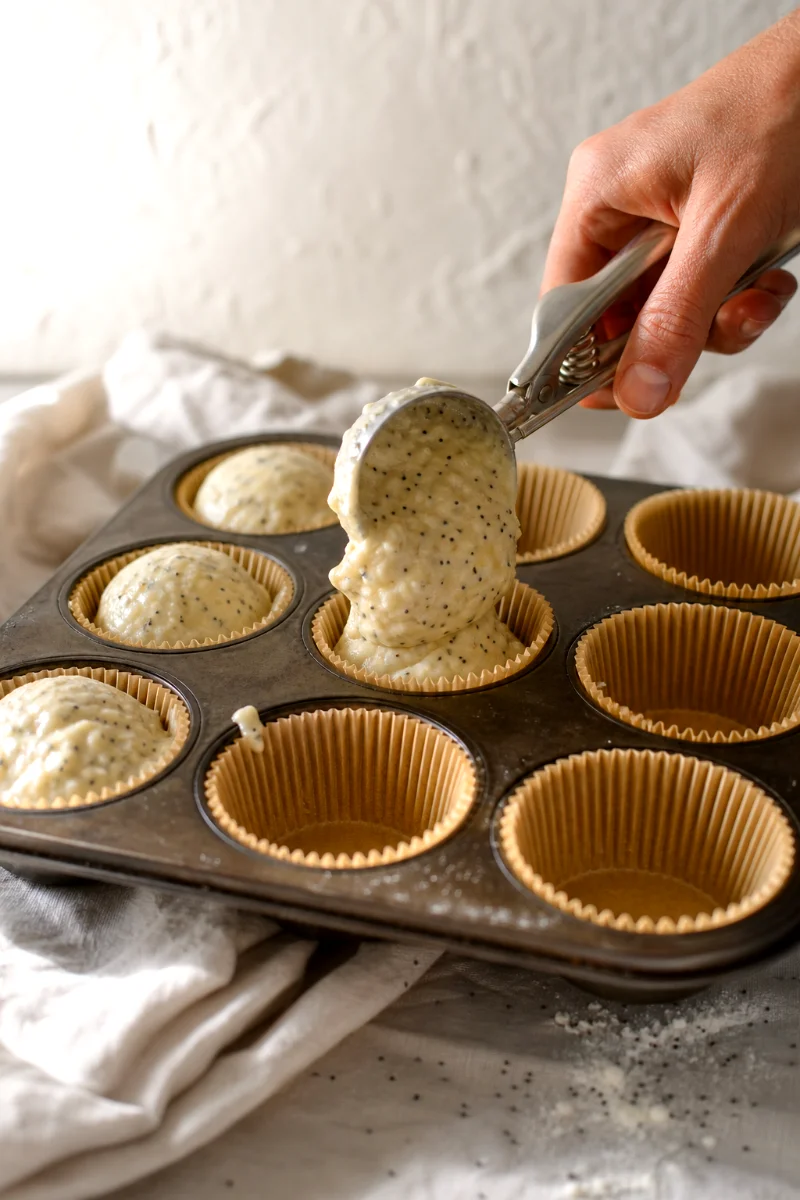 almond-poppy-seed-yogurt-muffins-scooping-batter