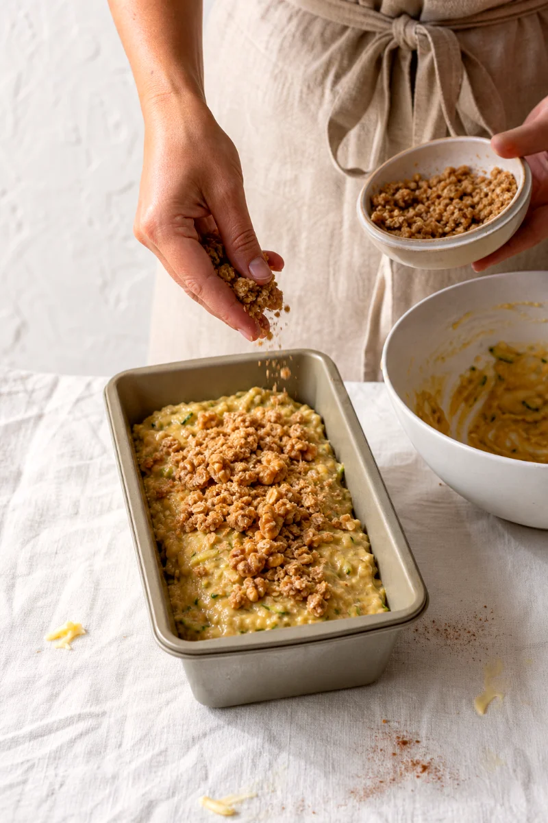 sprinkling-cinnamon-oat-streusel-on-banana-zucchini-bread