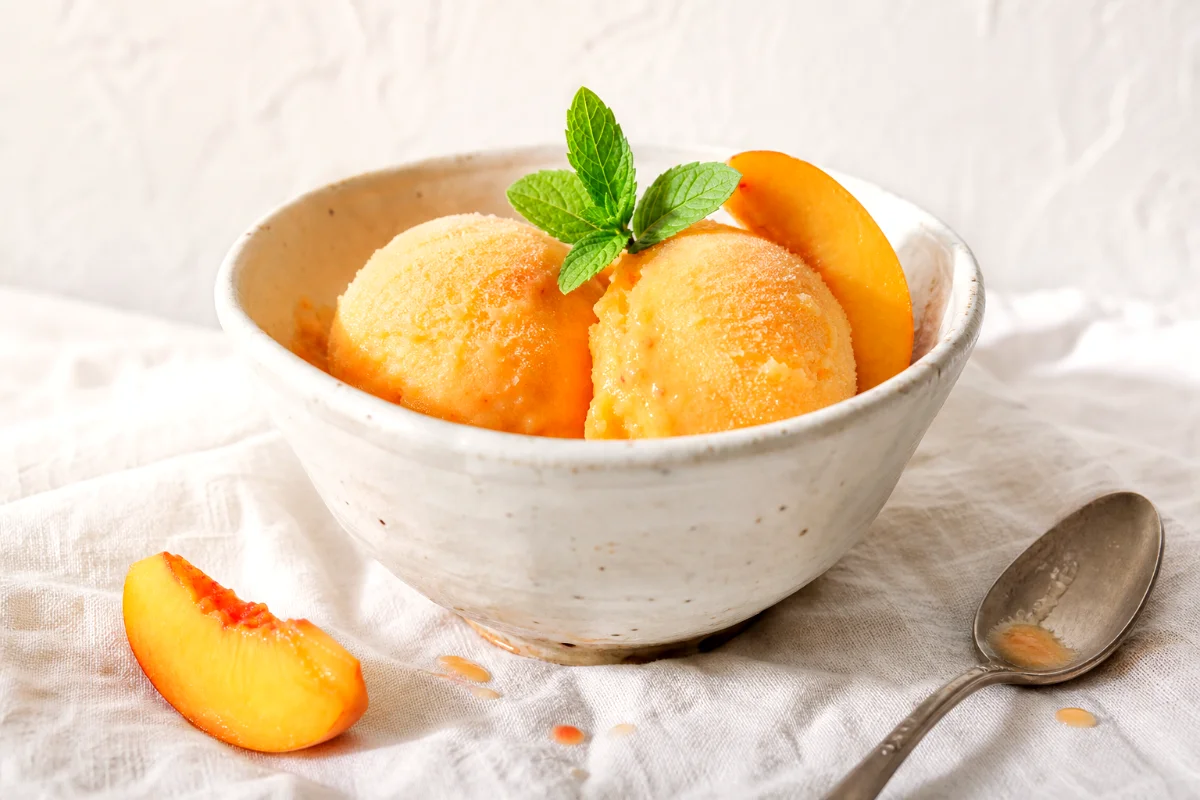 homemade-peach-sorbet-in-white-ceramic-bowl